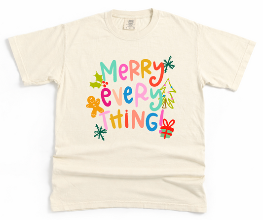 Beige t-shirt with colorful 'Merry Everything' text and Christmas graphics on a white background