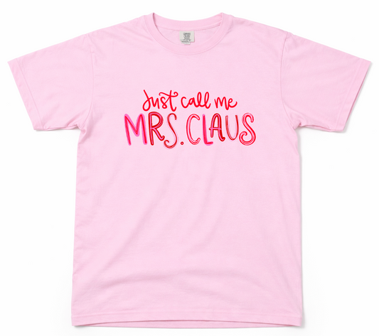 Pink t-shirt with 'Just call me Mrs. Claus' text on a white background