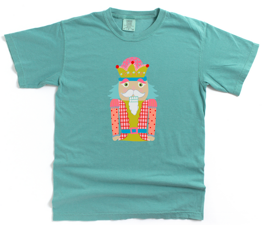 Teal t-shirt with a colorful graphic of a nutcracker on a white background