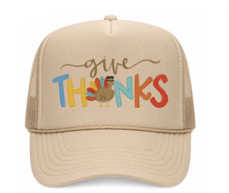 Beige trucker hat with 'give thanks' text and turkey graphic on a white background