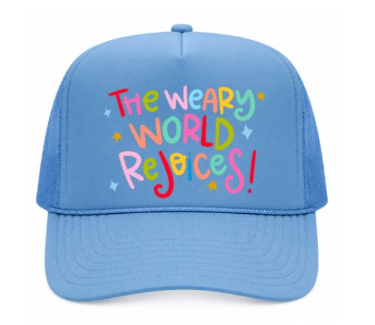 Blue cap with colorful text 'The Weary World Rejoices!' on a white background