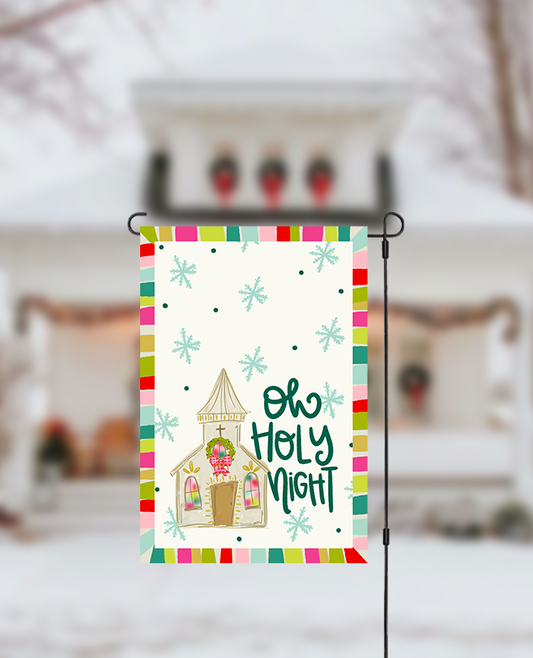 Decorative garden flag with a church illustration and 'Oh Holy Night' text, displayed outdoors.