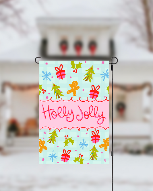 Decorative garden flag with Christmas designs and 'Holly Jolly' text, displayed outdoors.