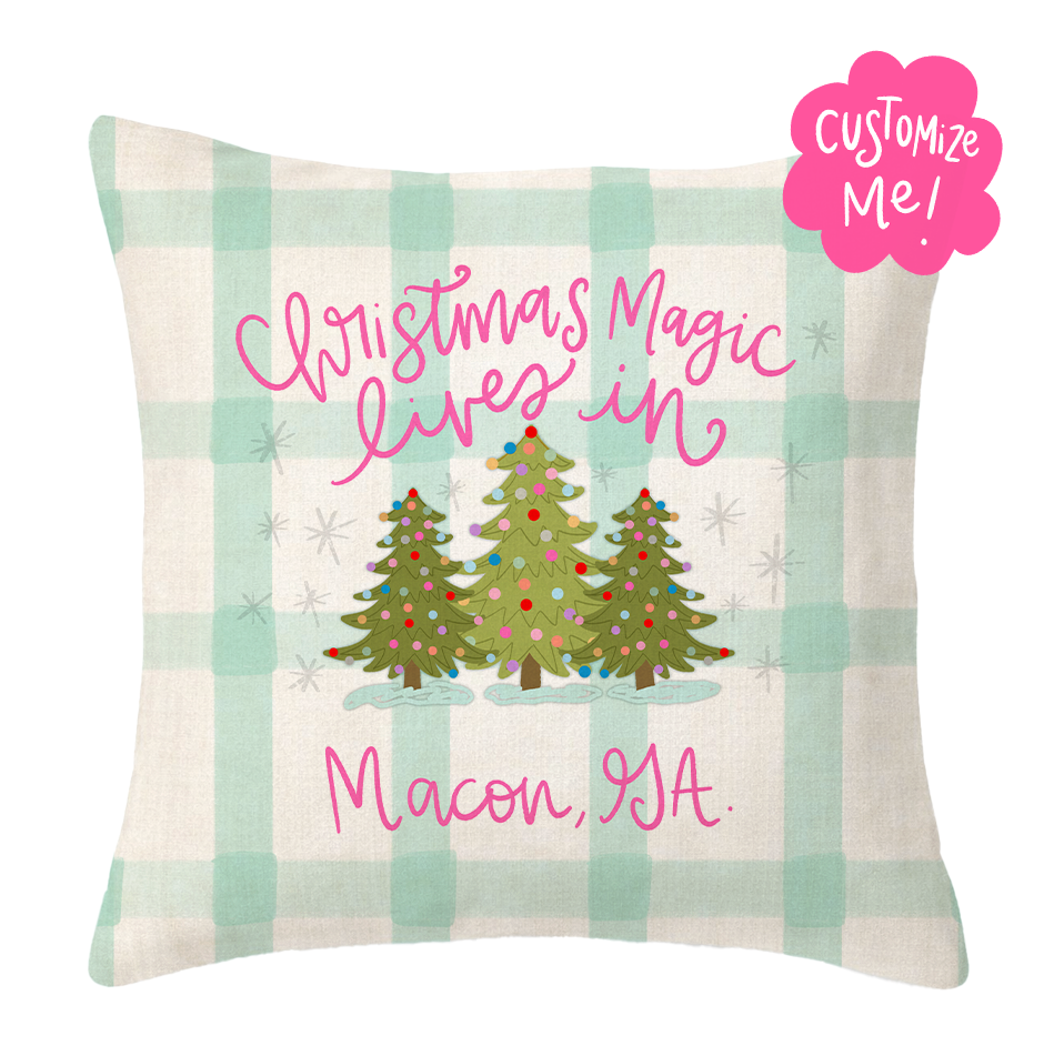 Decorative pillow with Christmas trees and text on a plaid background