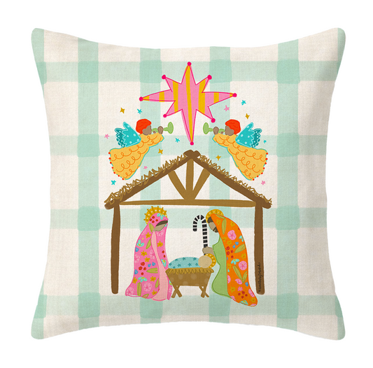 Decorative pillow with a nativity scene design on a plaid background