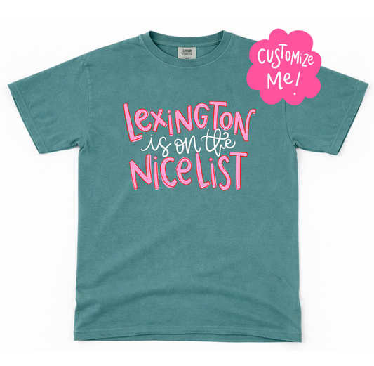 Teal t-shirt with pink text 'Lexington is on the nicelist' and a 'Customize Me!' label on a white background
