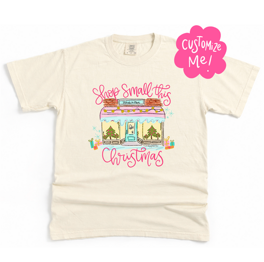 Beige t-shirt with Christmas-themed graphic and 'Shop Small this Christmas' text on a white background.