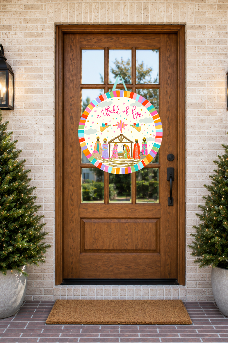 Decorative door decal with nativity scene design on a wooden door with brick wall background