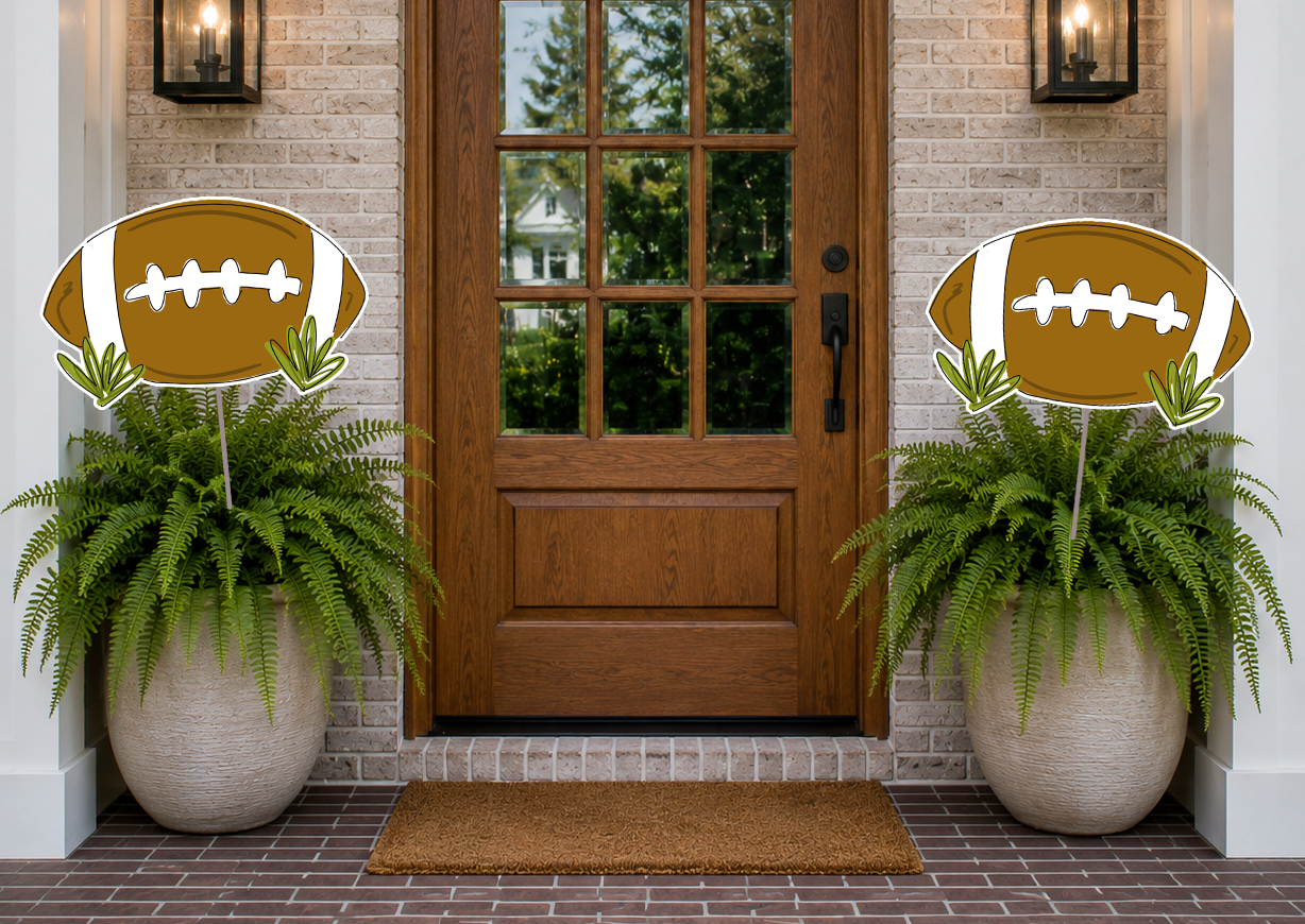 Decorative football signs with plants on either side of a wooden door.