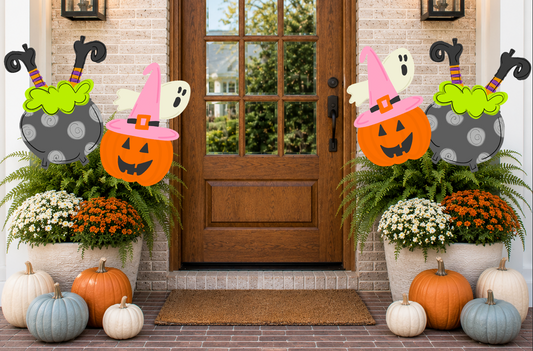 Halloween-themed decorations outside a house with pumpkins, ghosts, and witch hats.