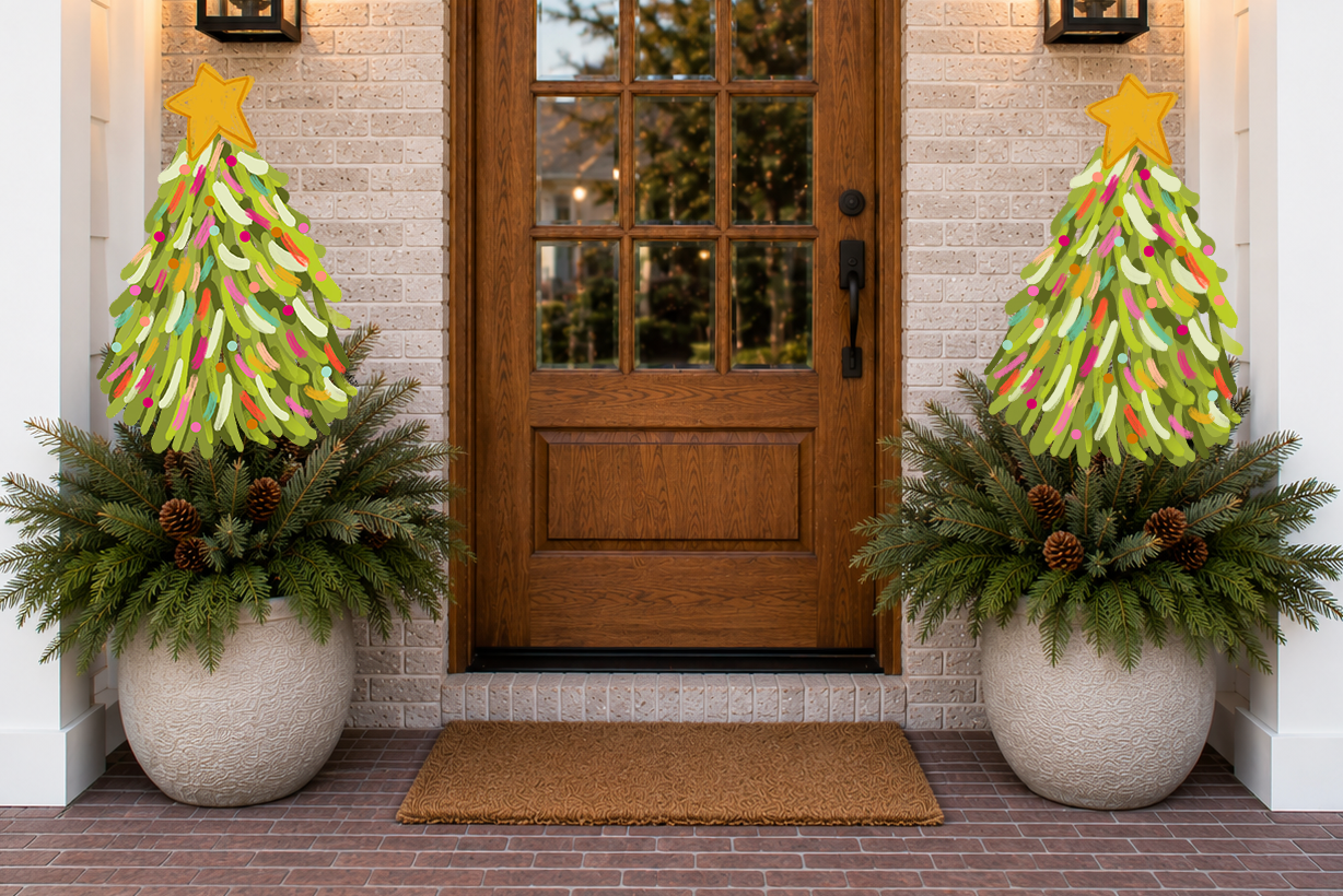 Decorative Christmas trees made from colorful paper on top of potted plants outside a house.