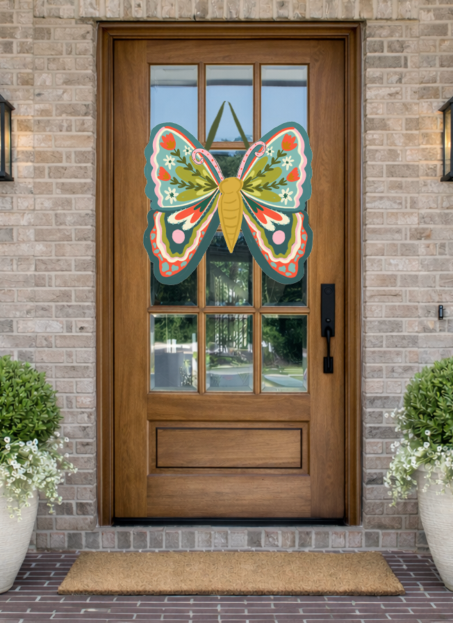 Doodles by Rebekah whimsical butterfly door decor featuring hand-drawn floral patterns and folk-art details on a rustic wooden front door.