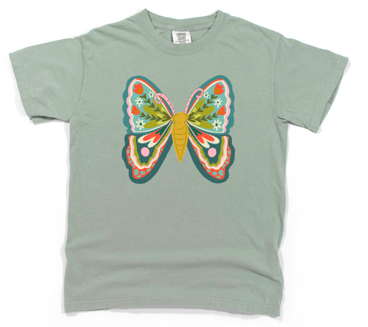 t-shirt with a colorful butterfly design on a light green background