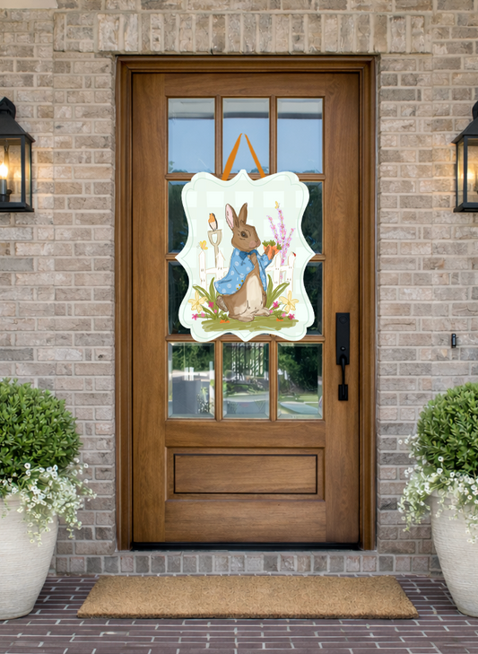 Doodles by Rebekah Peter Rabbit inspired Easter door decor featuring a whimsical bunny in a blue jacket with garden and picket fence illustrations.