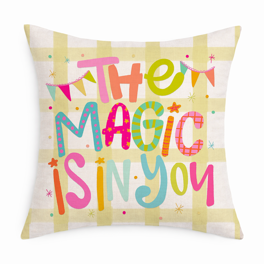 Decorative pillow with colorful text 'The Magic is in You' on a white background