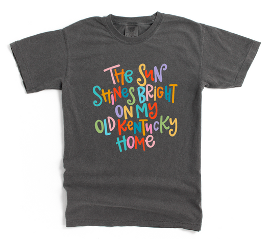Gray t-shirt with colorful text 'The Sun Shines Bright On My Old Kentucky Home' on a white background