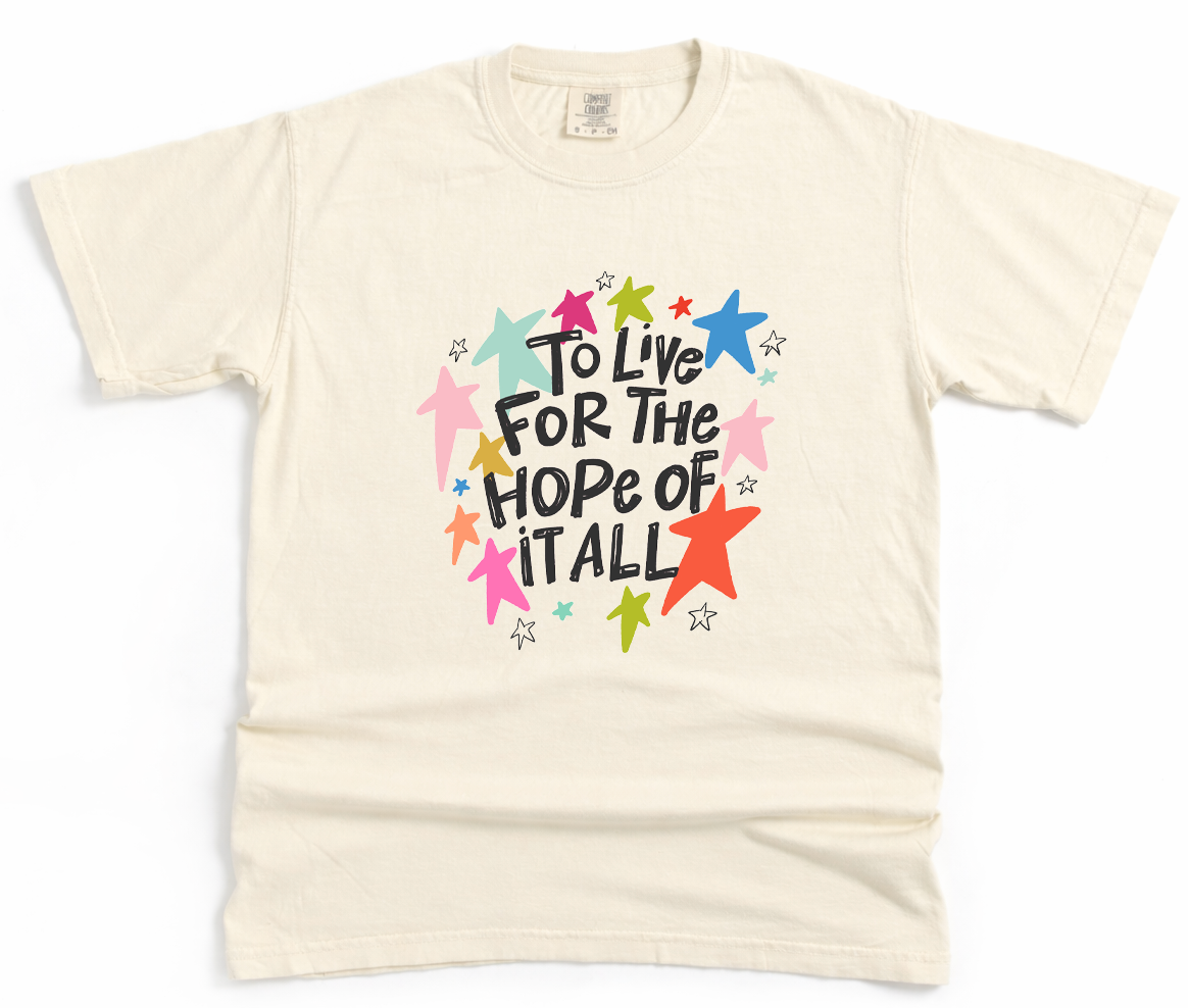 Beige t-shirt with colorful graphic and text on a white background
