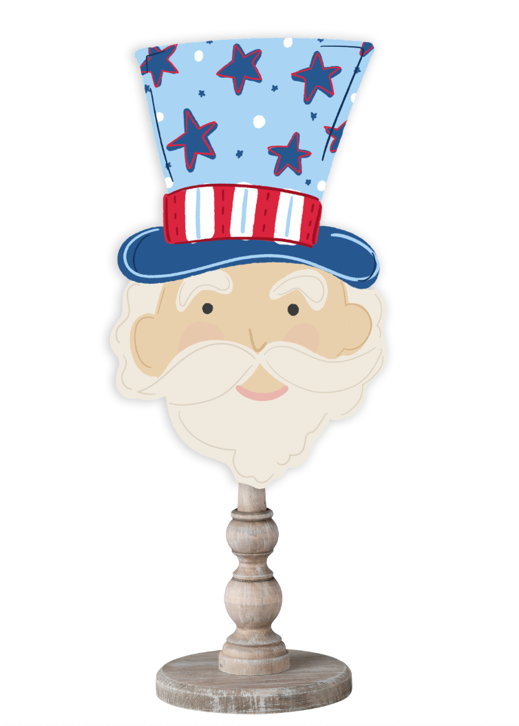 Doodles by Rebekah patriotic 4th of July decor featuring a whimsical Uncle Sam illustration with a red, white, and blue hat on a rustic wood stand.