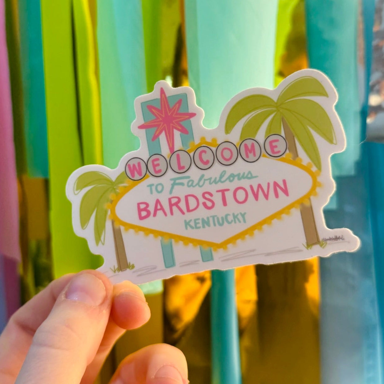 Doodles by Rebekah "Welcome to Fabulous Bardstown Kentucky" sticker. This whimsical hand-painted vinyl decal is a fun Las Vegas-inspired souvenir for Bardstown residents and visitors, perfect for decorating water bottles, laptops, or travel journals.