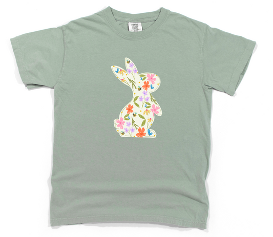 Green t-shirt with a colorful bunny design on a white background