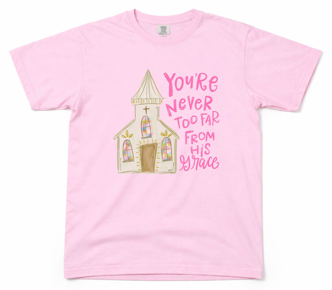 Pink t-shirt with a church graphic and text on a white background