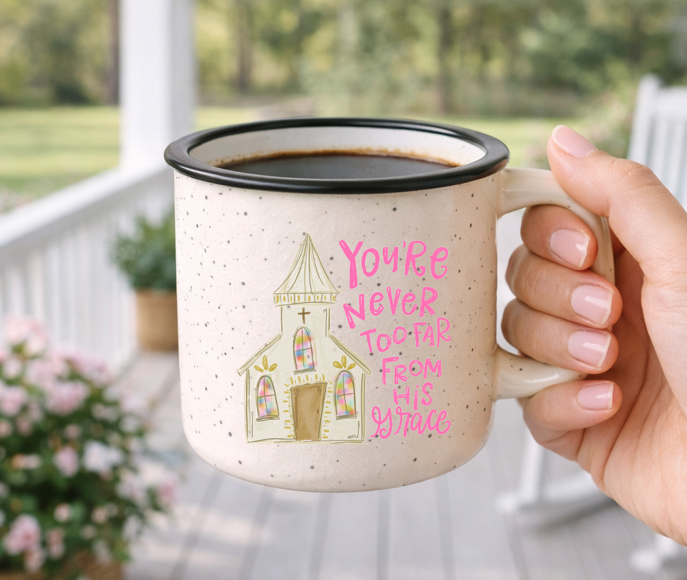 Doodles by Rebekah "You're Never Too Far From His Grace" religious mug. This whimsical hand-painted ceramic coffee cup features a charming church illustration and serves as an encouraging faith-based gift for friends, family, or church members.